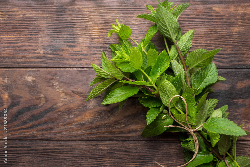 Fresh mint on wooden rustic background, overhead view, copy space Fresh mint on wooden rustic background, overhead view, copy space