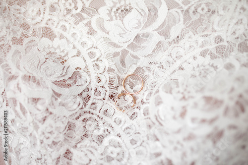 wedding rings lie on pink lace