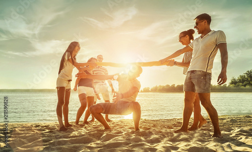 Happiness Friends funny game on the beach under sunset sunlight