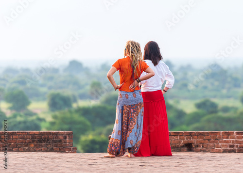 Two women in the background of a rural landscape in Bagan, Myanmar. Copy space for text.