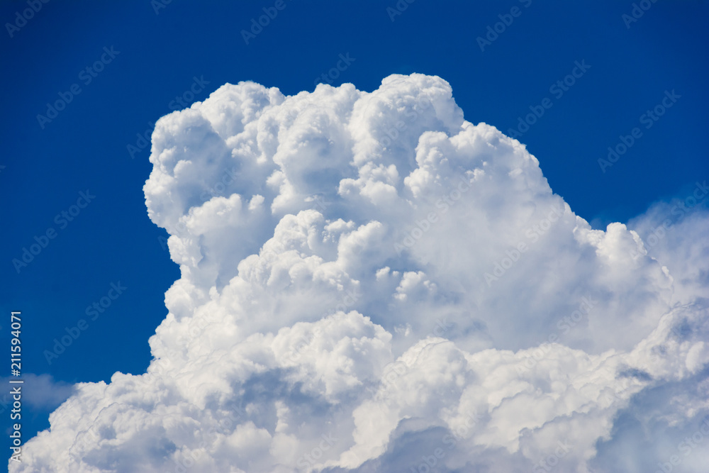 A large storm cloud on blue sky announces the approaching storm and the storm. A large storm cloud on blue sky announces the approaching storm and the storm.