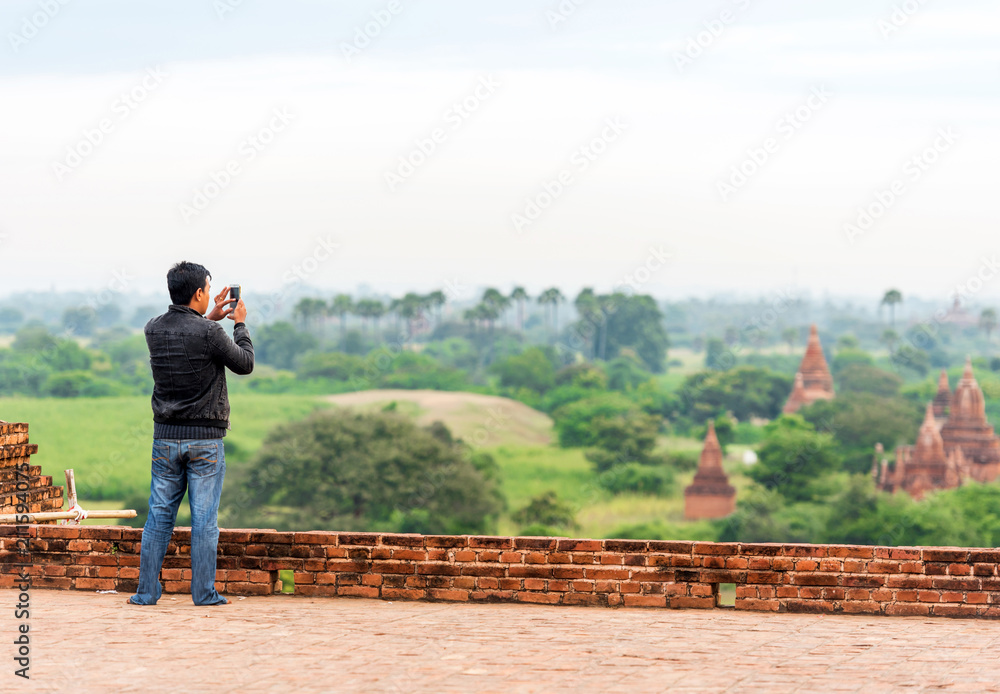 A man in the background of a landscape in Bagan, Myanmar. Copy space for text. A man in the background of a landscape in Bagan, Myanmar. Copy space for text.