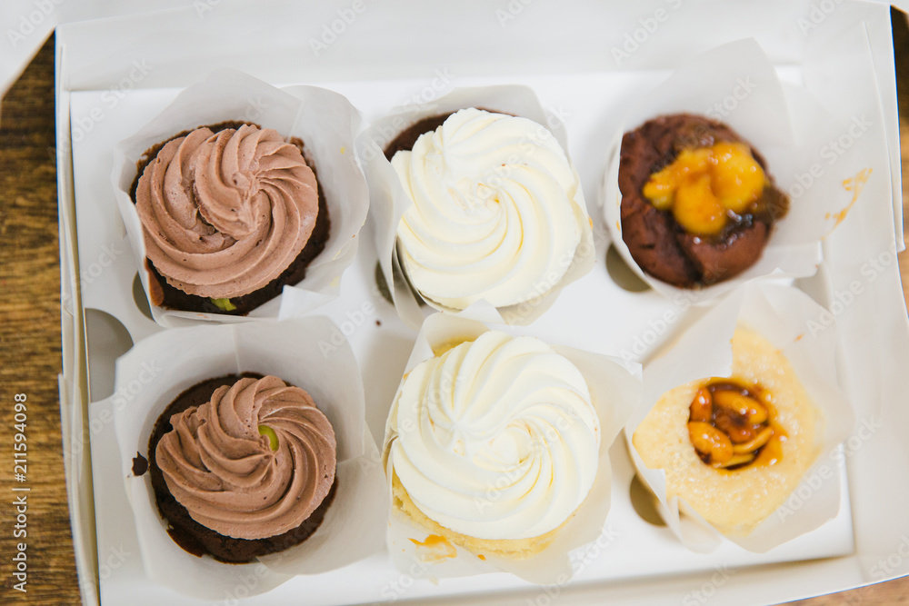Girls prepare beautiful and tasty desserts on a wooden table and decorate with fruits Girls prepare beautiful and tasty desserts on a wooden table and decorate with fruits