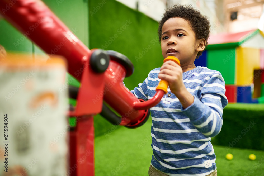 Colorful waist up portrait of cute African-American boy having fun playing in children center, copy space - obrazy, fototapety, plakaty 