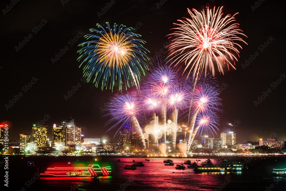 Fototapeta premium festive colorful firework light up the sky over the city at night scene for holiday festival and celebration background
