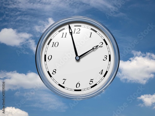 Large clock face with hands that mark the hours on sky background