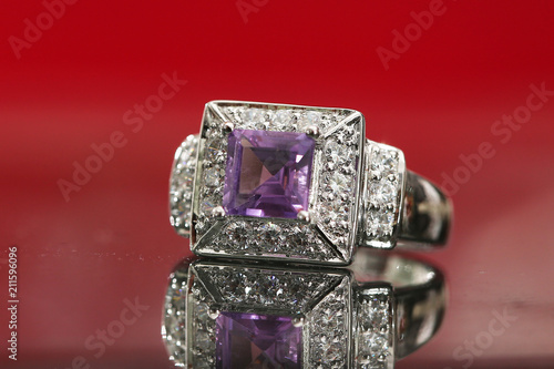 Purple gemstone on diamond ring