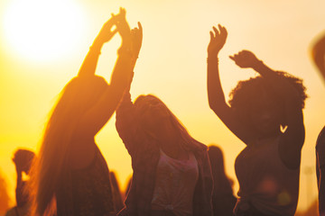 Sunset party dancers silhouettes at summer music festival