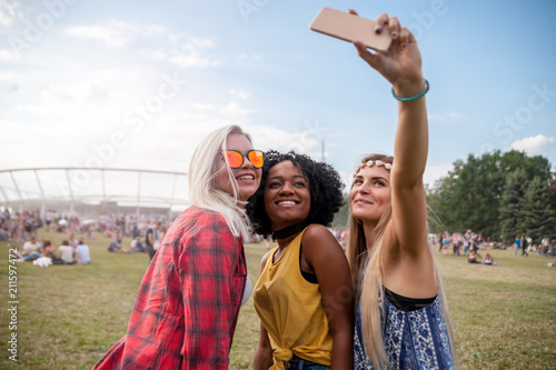 Selfie at summer music festival, group of friends having fun together