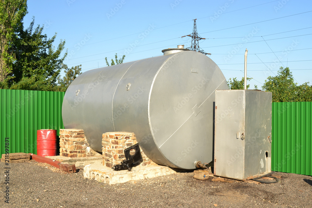 Huge oil, gas and liquid storage tank in open air field. Tank iron. Huge oil, gas and liquid storage tank in open air field. Tank iron.