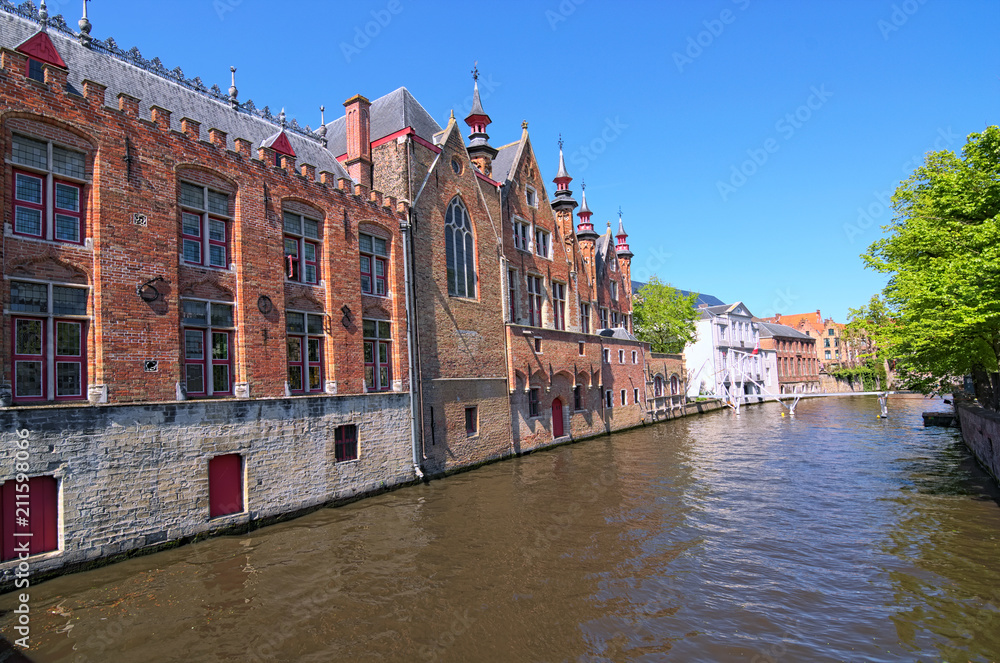 Beautiful view of the canal and traditional houses in the old town of Bruges (dutch: Brugge), Belgium. Spring landscape photo