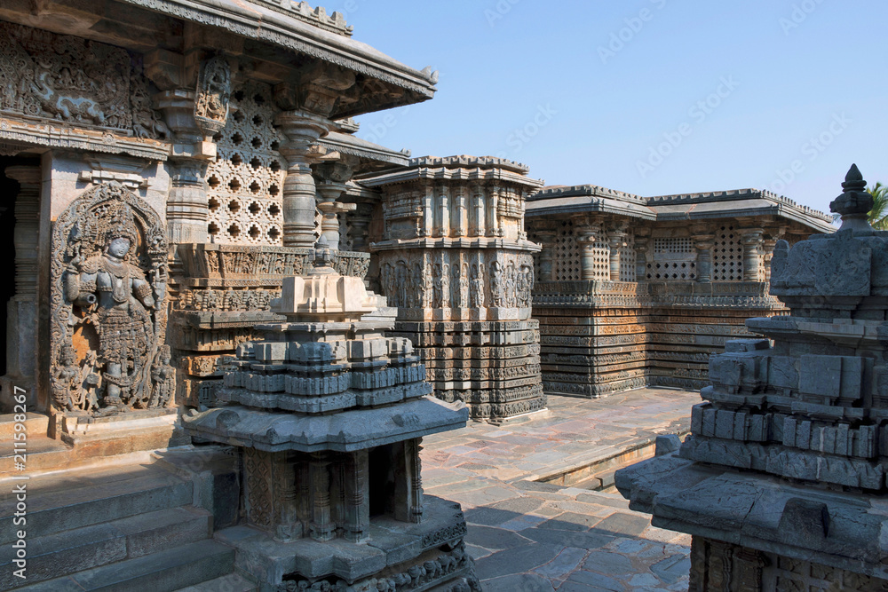 Fototapeta premium Small towers and dwarapla at the Shantaleswara shrine, Hoysaleshvara Temple, Halebid, Karnataka, View from South East.