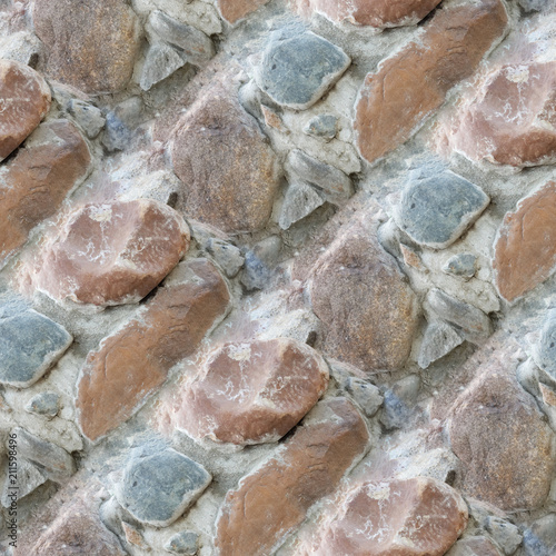 Seamless photo texture of building wall from stones in cement
