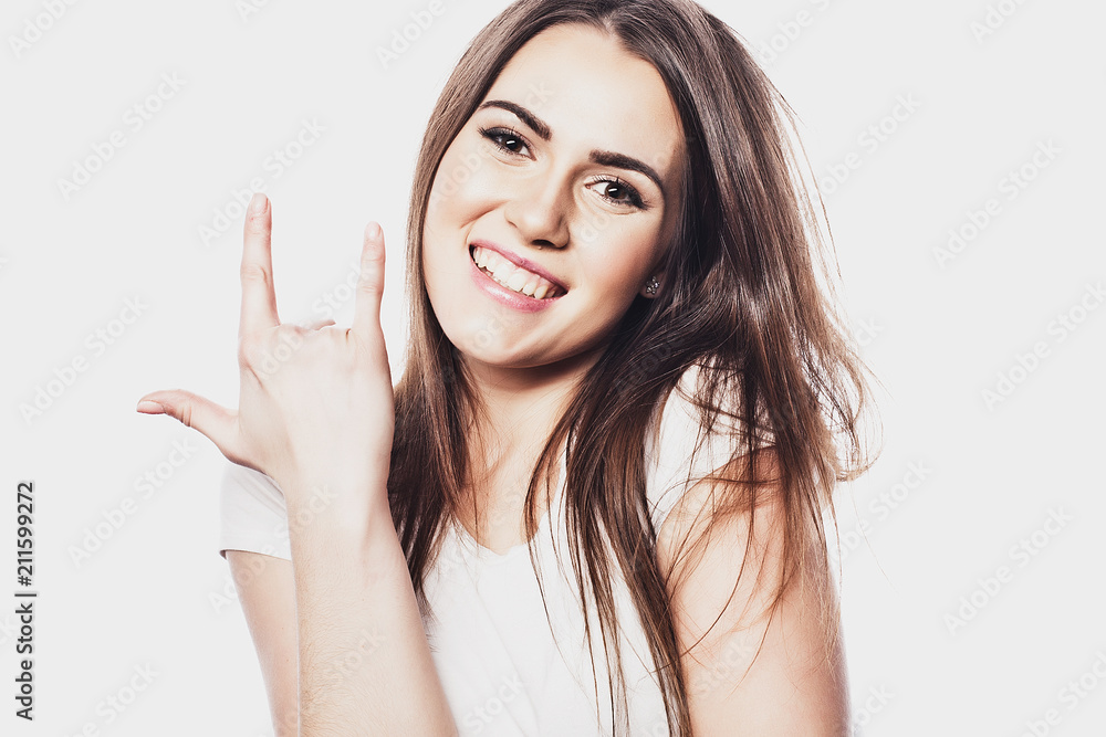 Portrait of a smiling happy woman showing victory sign and looking at camera Portrait of a smiling happy woman showing victory sign and looking at camera