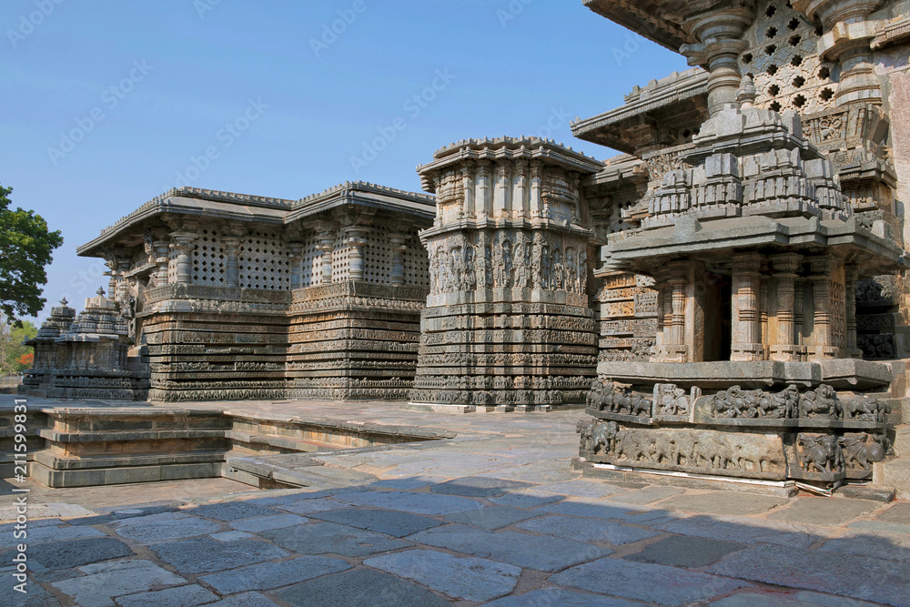 Small towers and ornate reliefs on walls, Hoysaleshvara Temple, Halebid, Karnataka, View from North East. East entrance to the Shantaleswara shrine is in the far left.