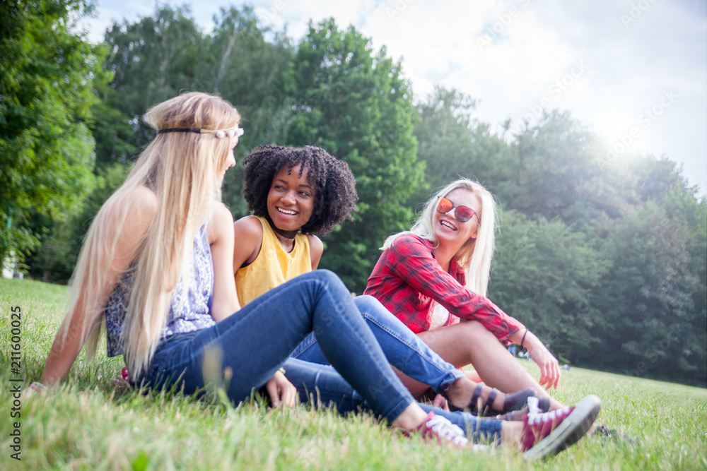 Group of friends having fun together sitting on grass Group of friends having fun together sitting on grass