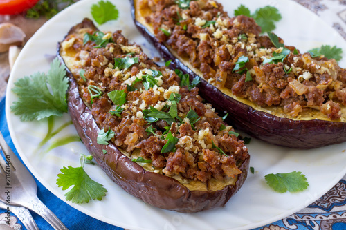 Classic baked eggplant close-up with meat, walnut and vegetables. Traditional middle eastern or arab dish.