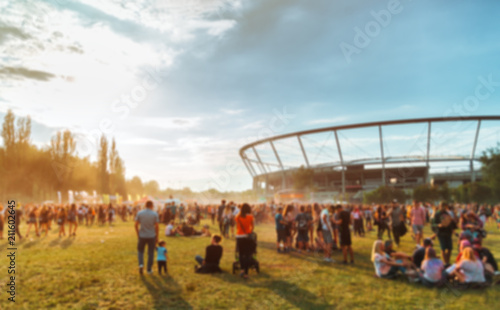 Audience at summer music festival, blurred image for background photo