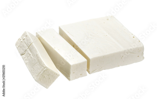 Greek feta. Sliced white cheese isolated on white background