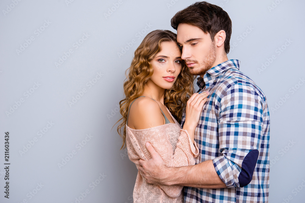 Portrait with copy space empty place of lovely sensual couple hugging, sexy girl looking at camera isolated on grey background Portrait with copy space empty place of lovely sensual couple hugging, sexy girl looking at camera isolated on grey background