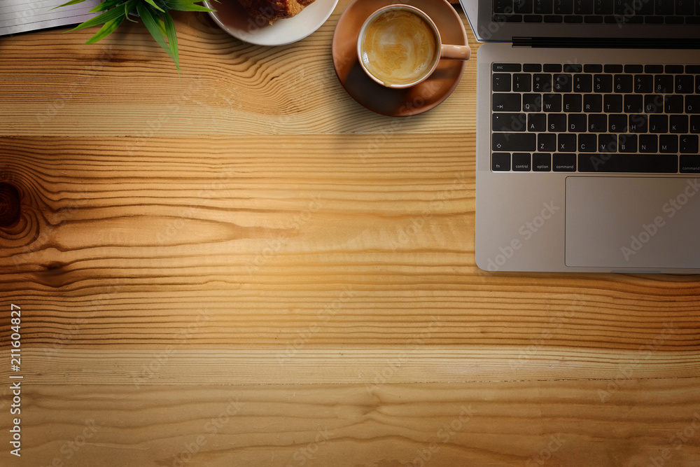 Office wooden desk with laptop, coffee cup and plant. Business workspace and copy space. Office wooden desk with laptop, coffee cup and plant. Business workspace and copy space.