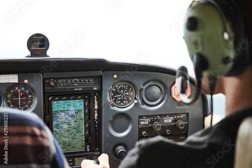 Closeup of a cockpit of cessna skyhawk 172 airplane with two pilots. photo