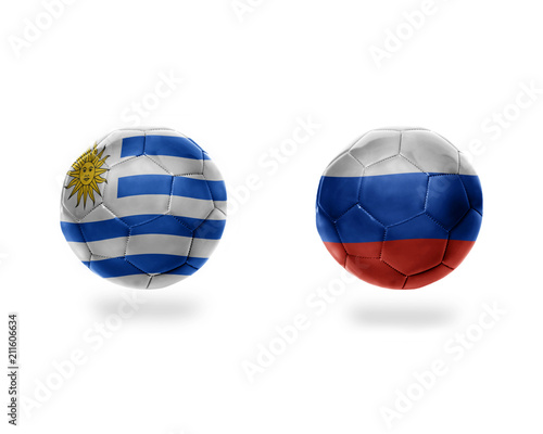 football balls with national flags of uruguay and russia.