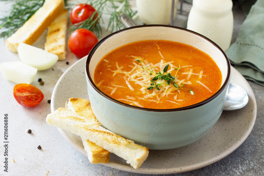 Puree soup tomato with croutons and cheese in a bowl on a light slate background. The concept of healthy eating. Diet menu. Copy space. Puree soup tomato with croutons and cheese in a bowl on a light slate background. The concept of healthy eating. Diet menu. Copy space.