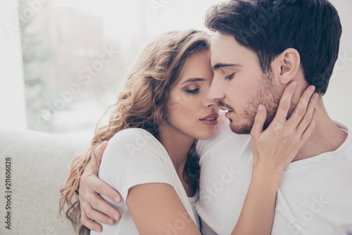 Recreation delight weekend holiday happiness satisfaction concept. Head shot portrait of romantic sexy couple keeping eyes closed enjoying time together kissing bonding indoor photo