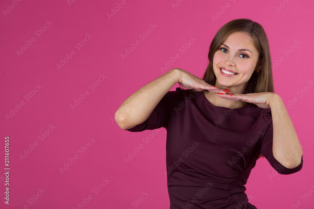 beautiful young girl with a smile on her face with flowing hair on a pink background beautiful young girl with a smile on her face with flowing hair on a pink background
