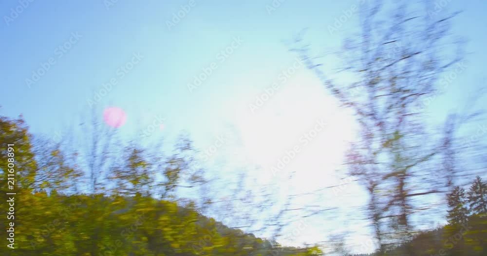 Autumn Driving - Driving on a curvy mountain road on a beautiful autumn day. POV shot from the side window of a car, hand-held camera, shot against the sun - ProRes Autumn Driving - Driving on a curvy mountain road on a beautiful autumn day. POV shot from the side window of a car, hand-held camera, shot against the sun - ProRes