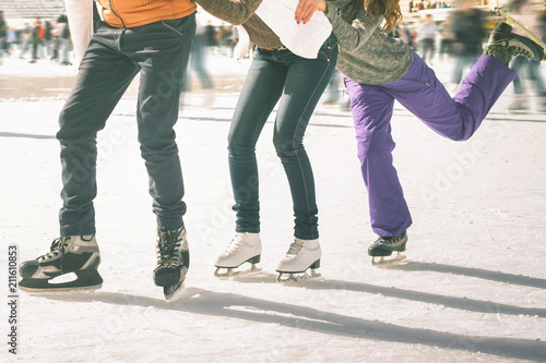 Obraz na plátně Funny teenagers girls and boy skating outdoor, ice rink