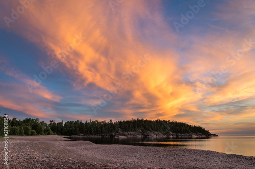 Fiery sunset sky over Lake Superior coastline © Les Palenik