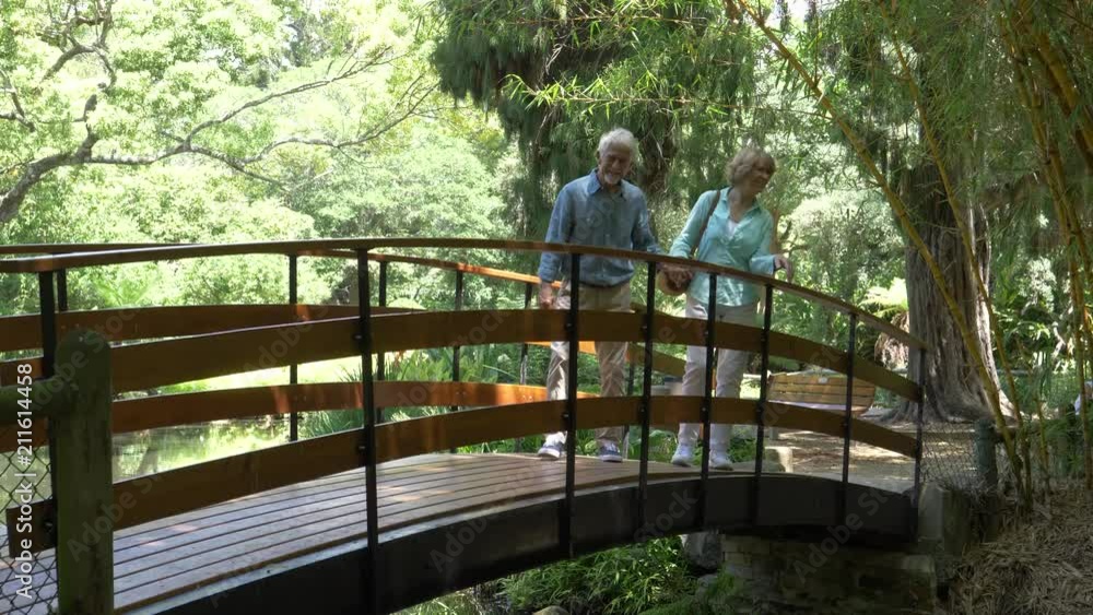Senior couple walking in a garden Senior couple walking in a garden