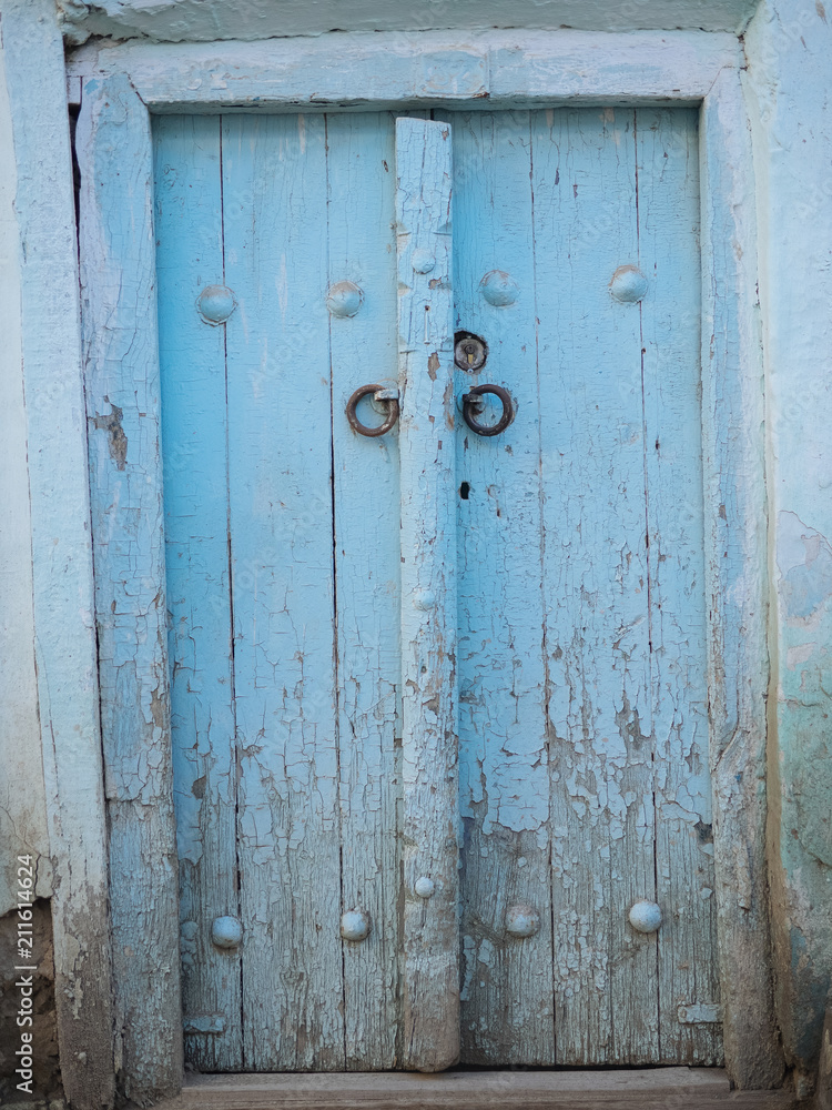 Aged wooden door in metal rivets Aged wooden door in metal rivets