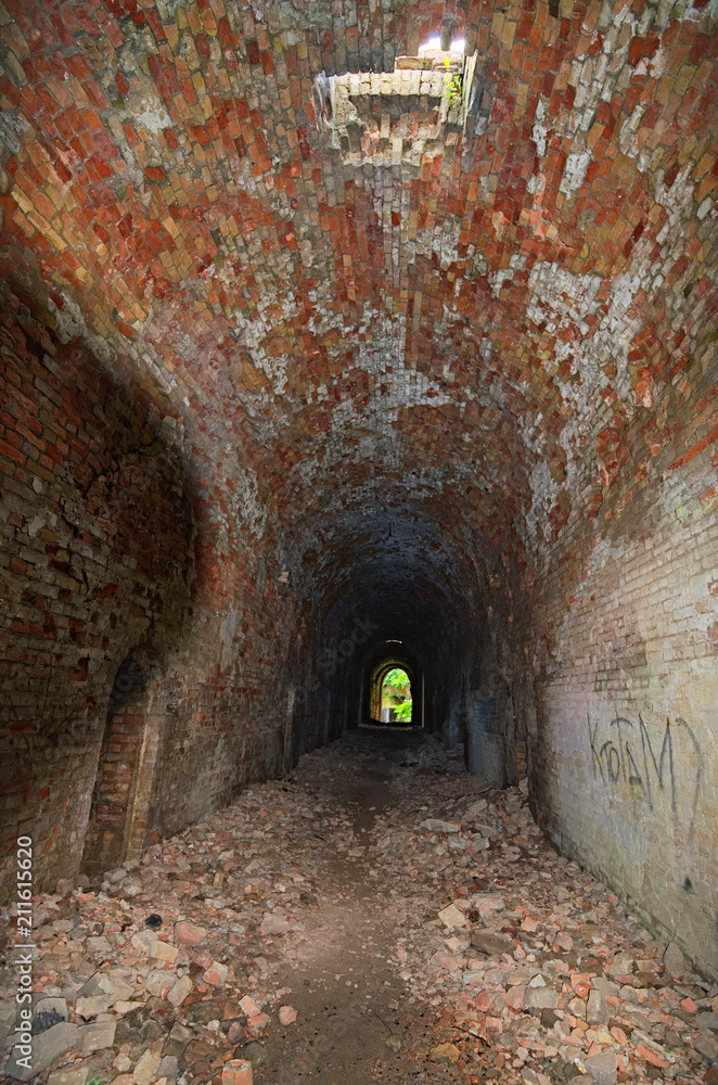 The Light at the End of the Tunnel. Abandoned Tarakaniv Fort in the summer day. Tarakaniv, Rivne oblast, Ukraine