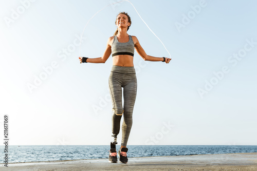 Disabled sports woman jumping with skipping rope