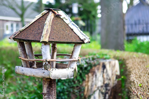 Bird feeder made in a form of a house in a park