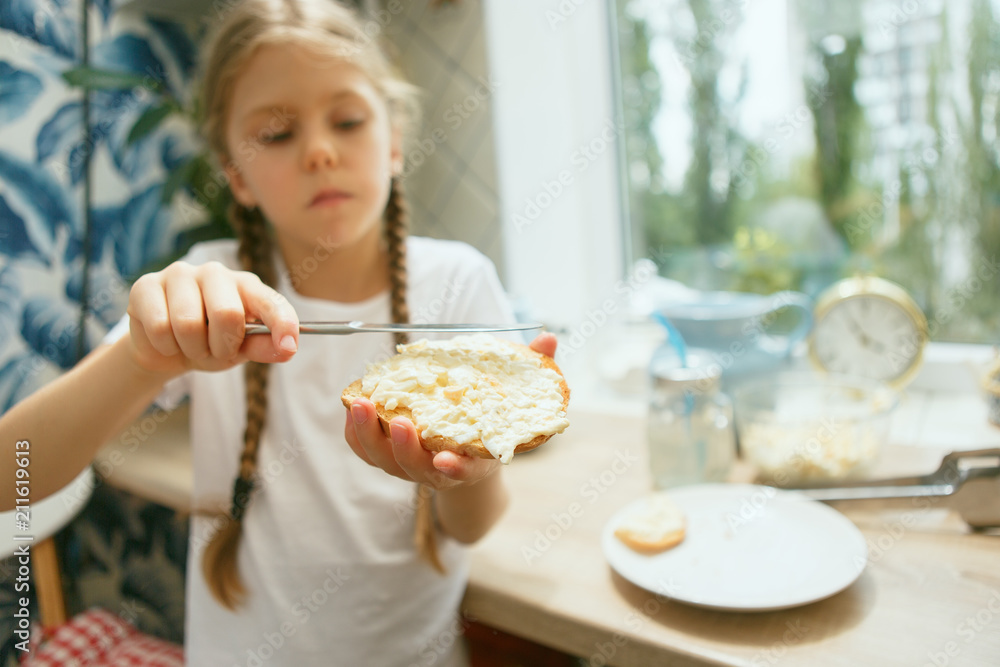 Beautiful girl in her kitchen in the morning preparing breakfast Beautiful girl in her kitchen in the morning preparing breakfast