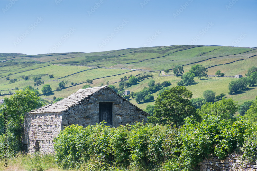 Yorkshire Dales with stone farm building in foreground
