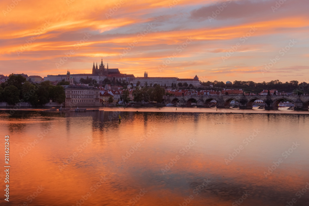The View on Prague gothic Castle with Charles Bridge after the sunset, Czech Republic - Beautiful reflections of Vltava river