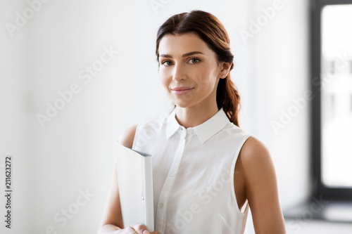 business, people and corporate concept - businesswoman or realtor with folder at office photo