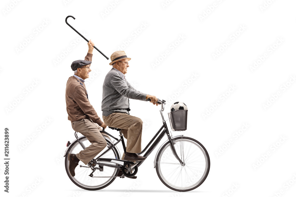 Joyful seniors with a cane and a football riding a bicycle together Joyful seniors with a cane and a football riding a bicycle together
