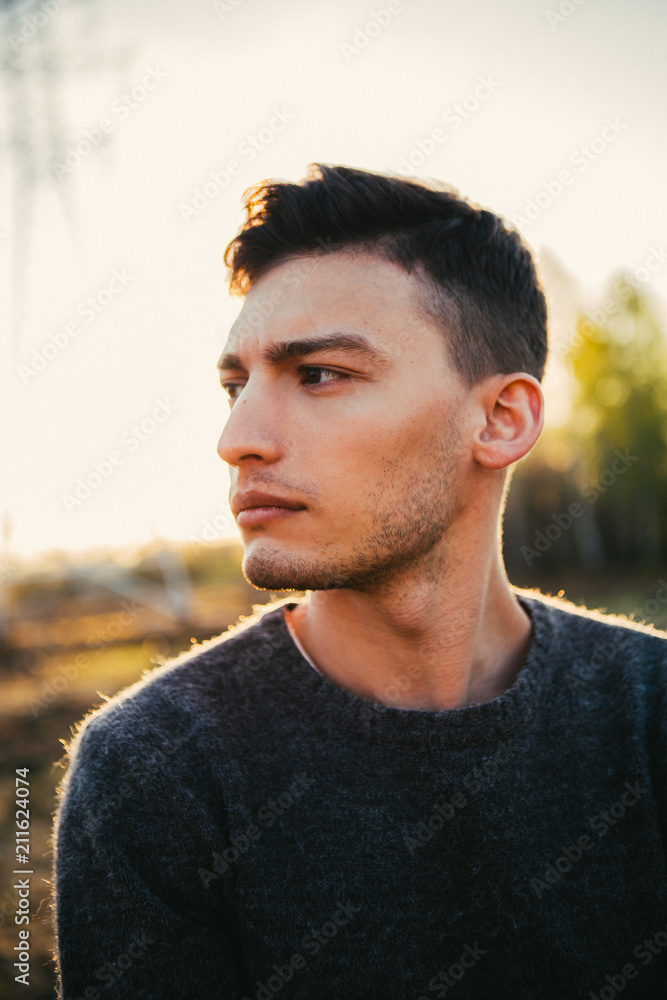 portrait of a guy in the field on a sunset background portrait of a guy in the field on a sunset background