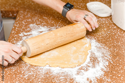 Housewife rolling out dough on kitchen table, cooking and baking recipe for pie