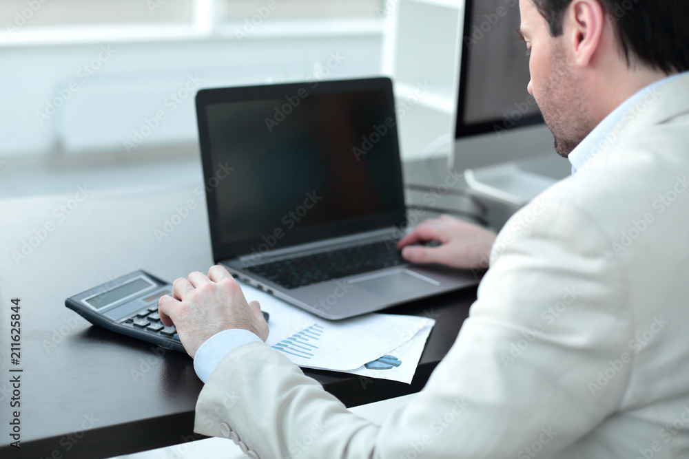 close up.Businessman analyzing investment charts close up.Businessman analyzing investment charts