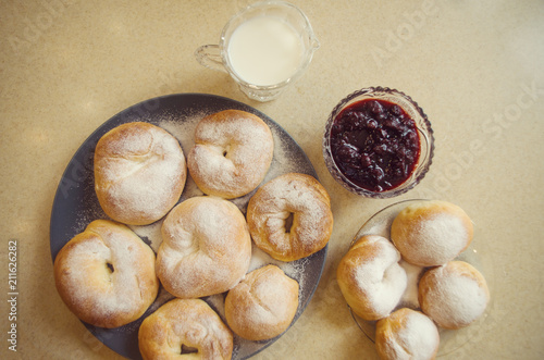 Homemade buns with sugar powder. Fresh bakery for delicious smell. Hygge food. Buns with jam and milk.