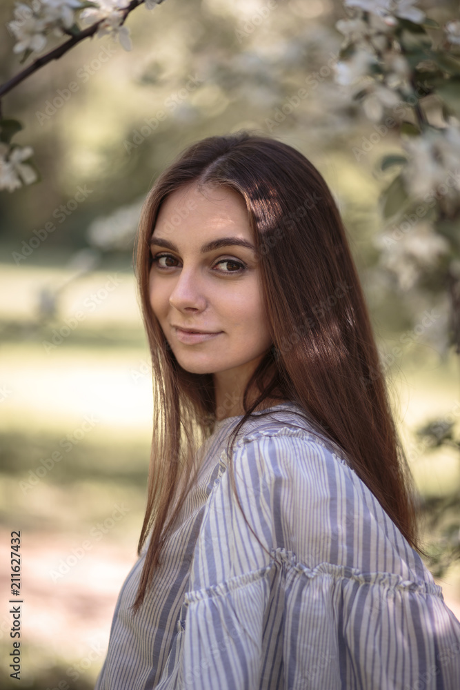 Pretty young woman in a summer garden, casual romantic style with hat Pretty young woman in a summer garden, casual romantic style with hat