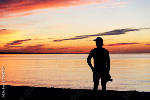 Silhouette of man with the camera and sunset. Photographer and sunset. Lake Ontario. Rochester, USA