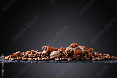 Roasted coffee beans with spices .